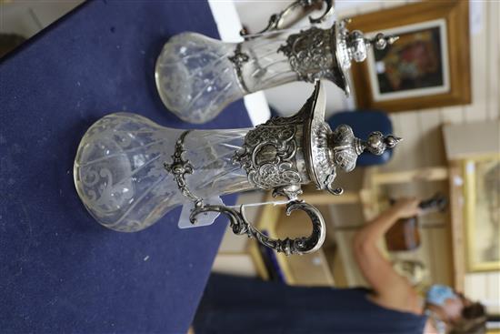 A pair of 19th century German 800 white metal mounted glass claret jugs,